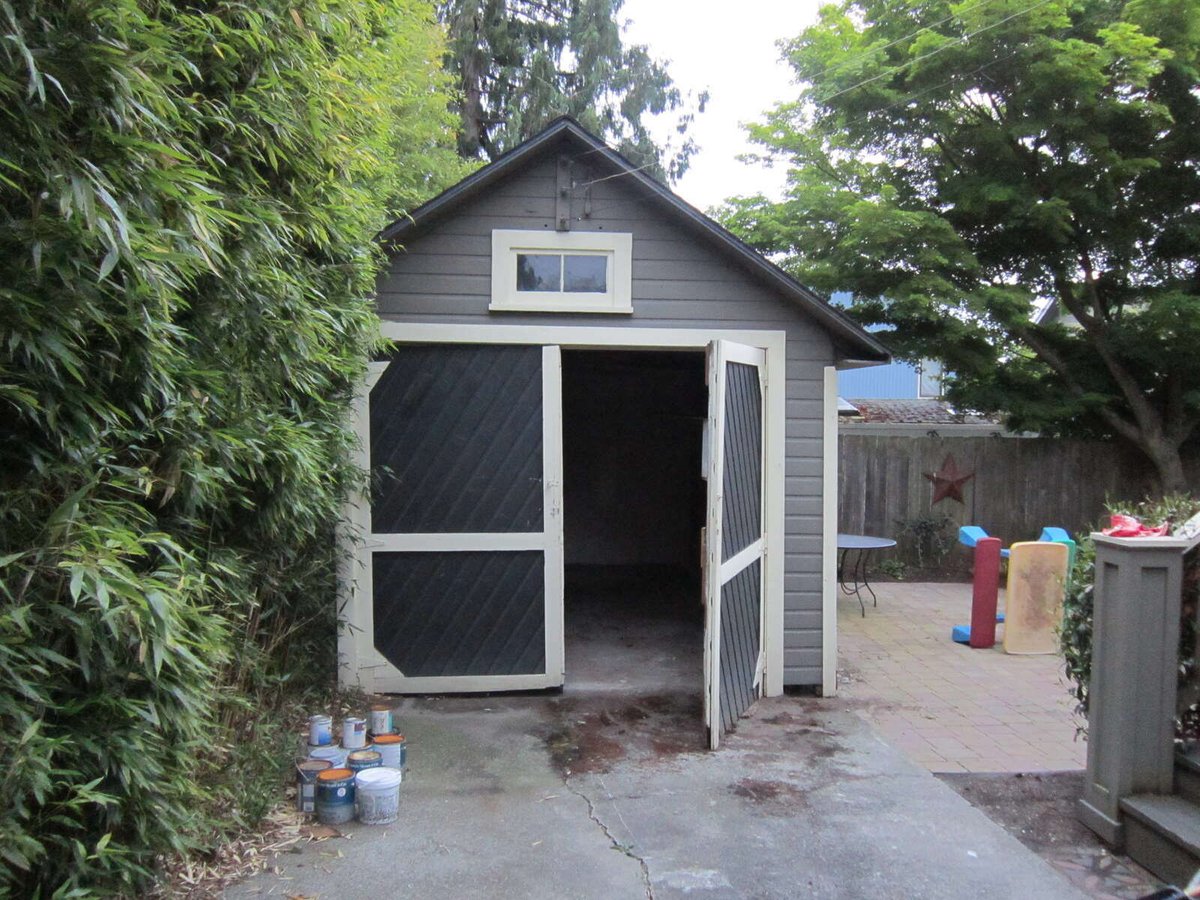 A compact garage in need of remodeling surrounded by greenery in Seattle, before renovation by CB Construction