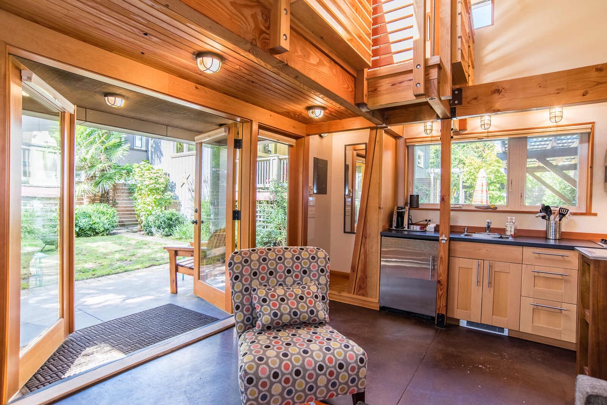 Interior view of an ADU kitchen with natural wood beams and bright windows, remodeled by CB Construction in Seattle