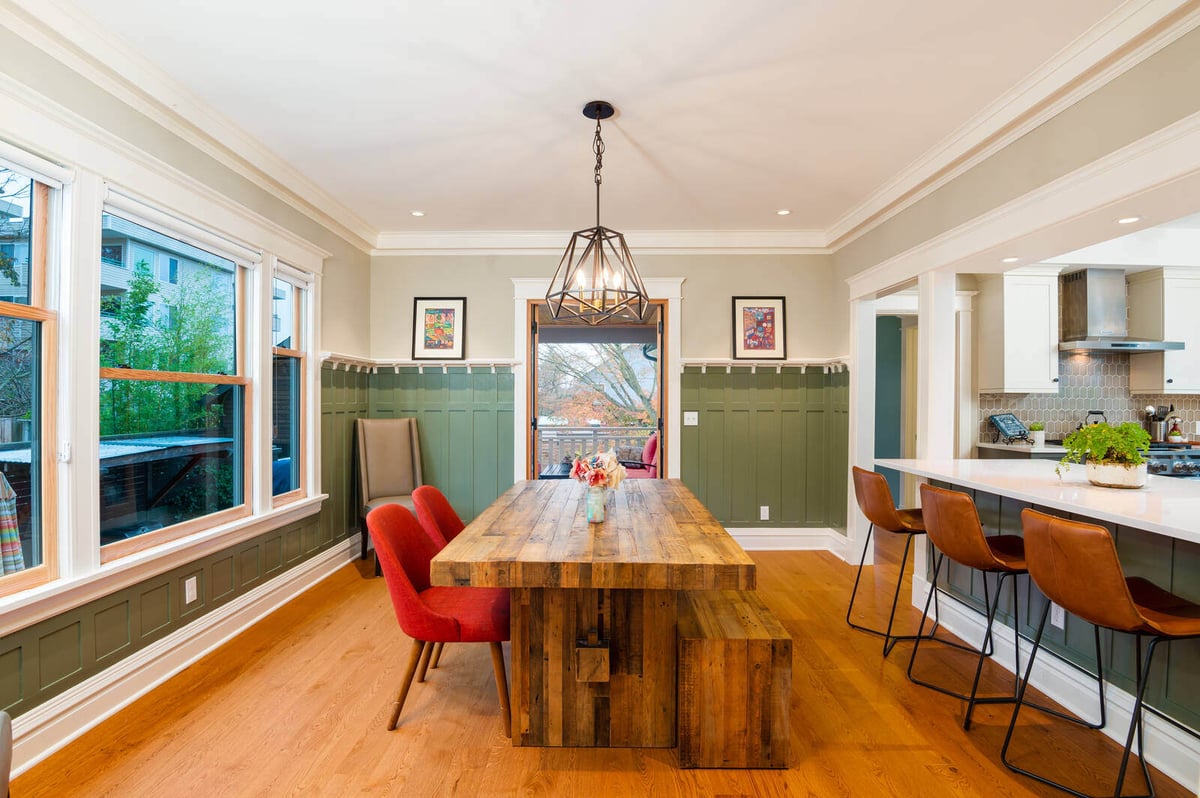 Outdoor patio with red cushioned seating and sliding glass doors by CB Construction in Seattle