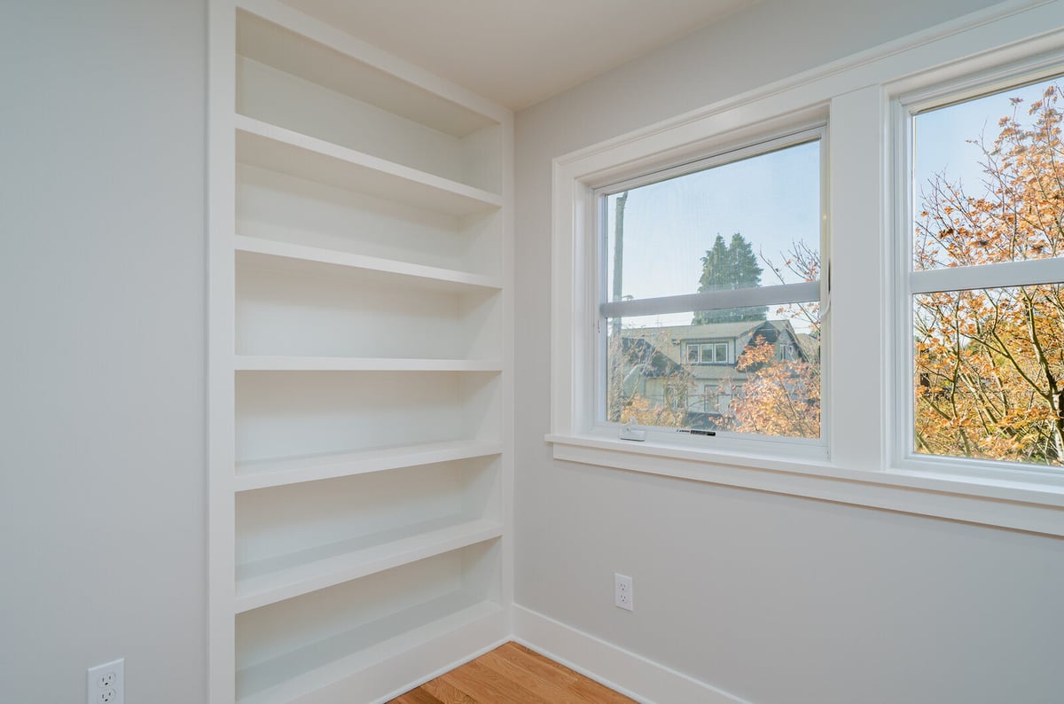 Built-in shelving next to a large window, part of a whole home remodel by CB Construction in Seattle