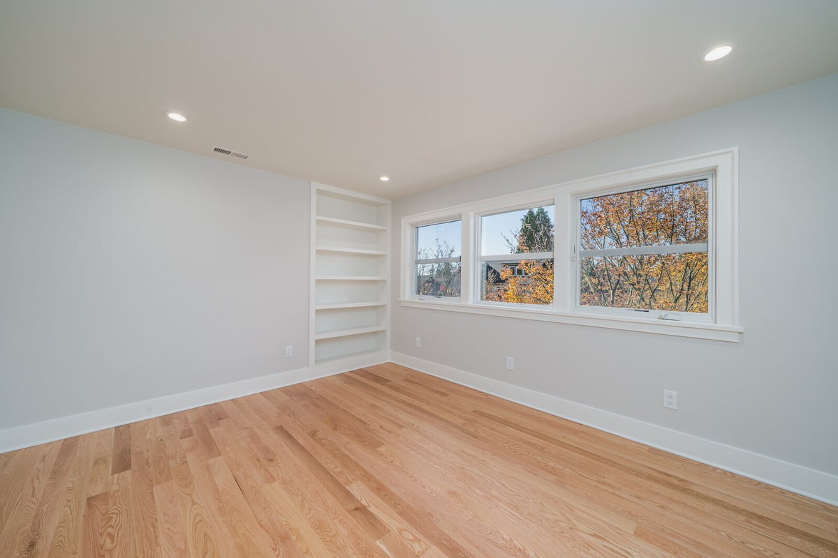 Cozy reading nook with built-in shelves and large windows, part of a CB Construction home remodel in Seattle