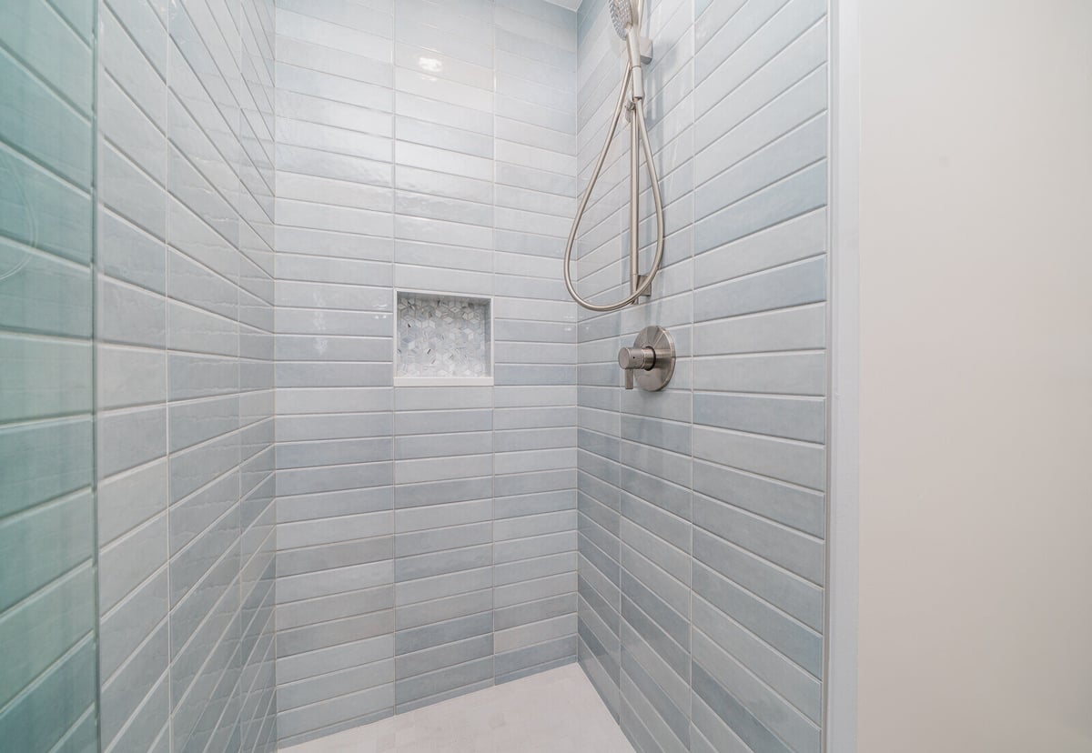 Detail of blue-tiled shower with built-in niche, part of a Seattle home renovation by CB Construction