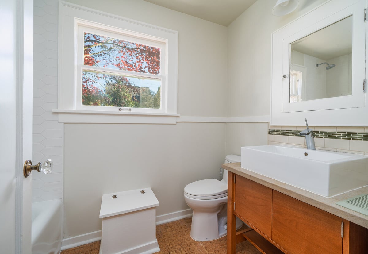 Modern bathroom in Seattle featuring a vanity with vessel sink and natural light, remodeled by CB Construction