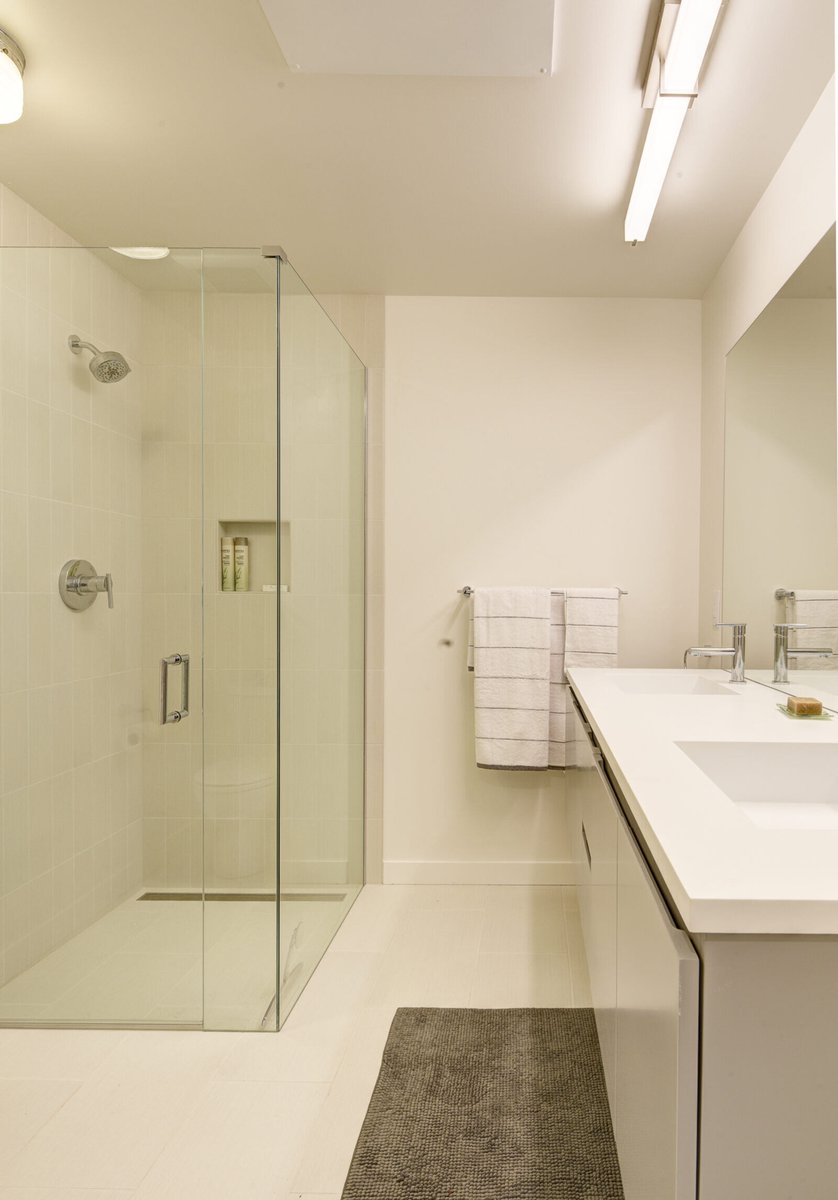 Basement ADU bathroom in Seattle with a walk-in glass shower, remodeled by CB Construction