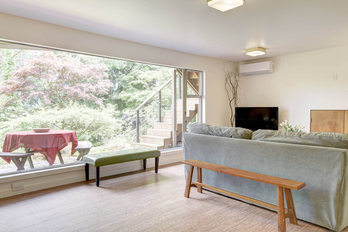 Bright basement ADU living room with modern seating and a view of the garden, remodeled by CB Construction in Seattle