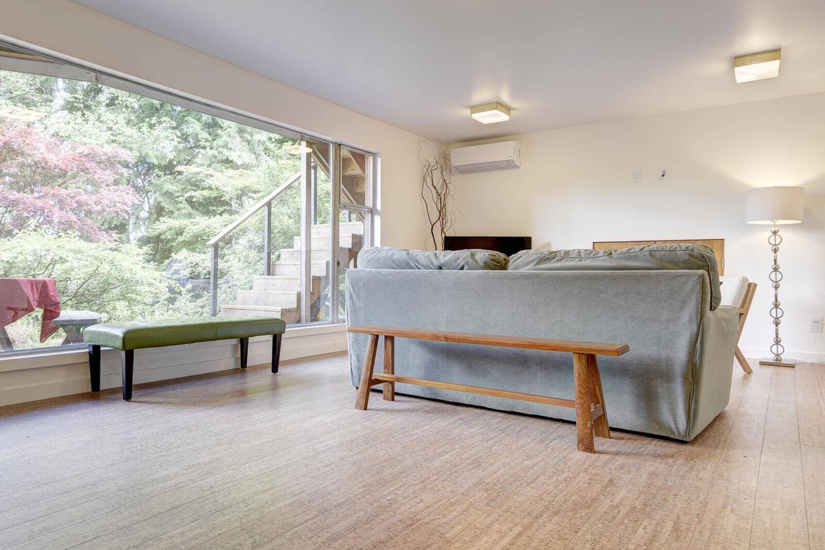 Bright living area in a Seattle basement ADU, featuring large windows with garden views, remodeled by CB Construction