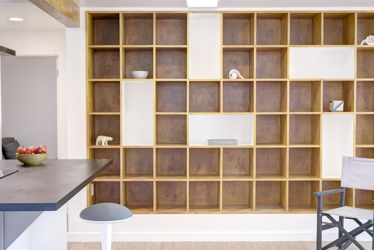 Custom shelving and modern kitchen in a Seattle basement ADU remodel by CB Construction