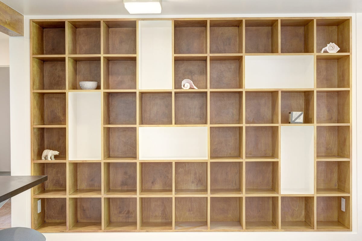 Custom wooden shelving in a Seattle basement ADU, built by CB Construction for added storage and design