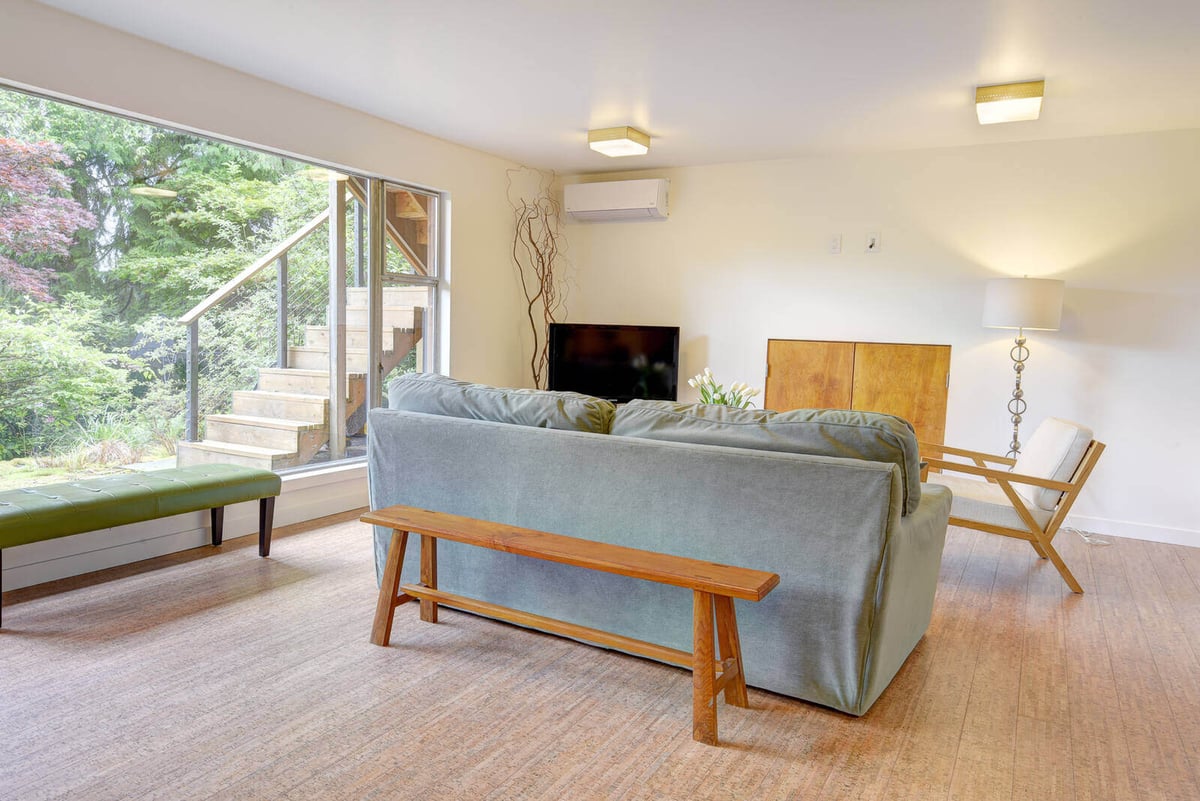 Living room in a basement ADU remodel by CB Construction in Seattle, featuring modern furniture and large windows