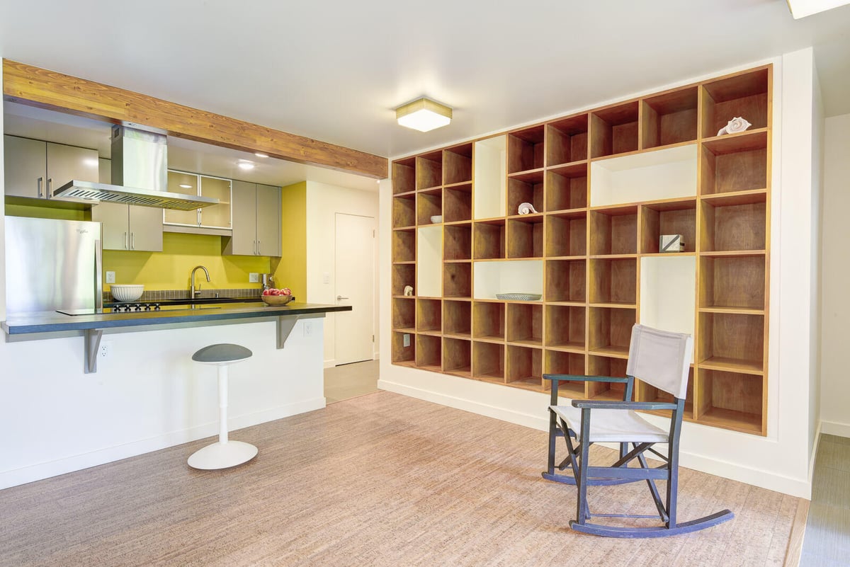 Modern basement ADU kitchen in Seattle, featuring a chalkboard wall and stainless steel appliances, remodeled by CB Construction