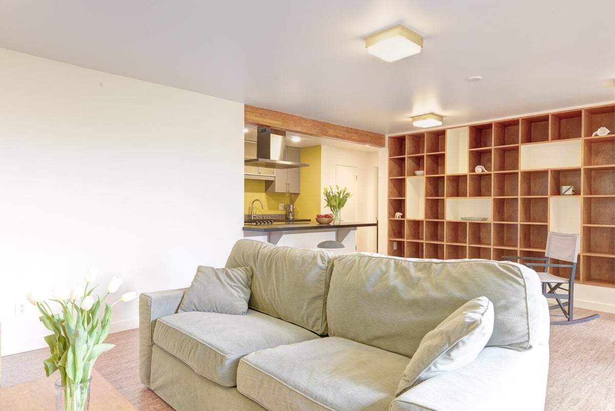 Open concept living room and kitchen in a Seattle basement ADU by CB Construction