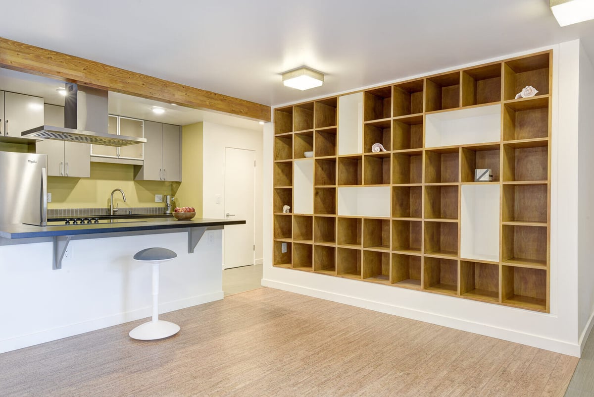 Open-concept kitchen with custom shelving in a Seattle basement ADU, designed by CB Construction