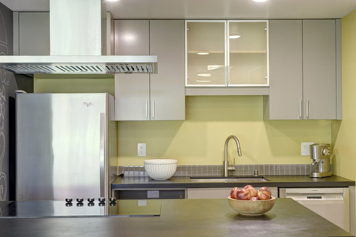 Sleek, modern kitchen in a Seattle basement ADU with stainless steel appliances, remodeled by CB Construction