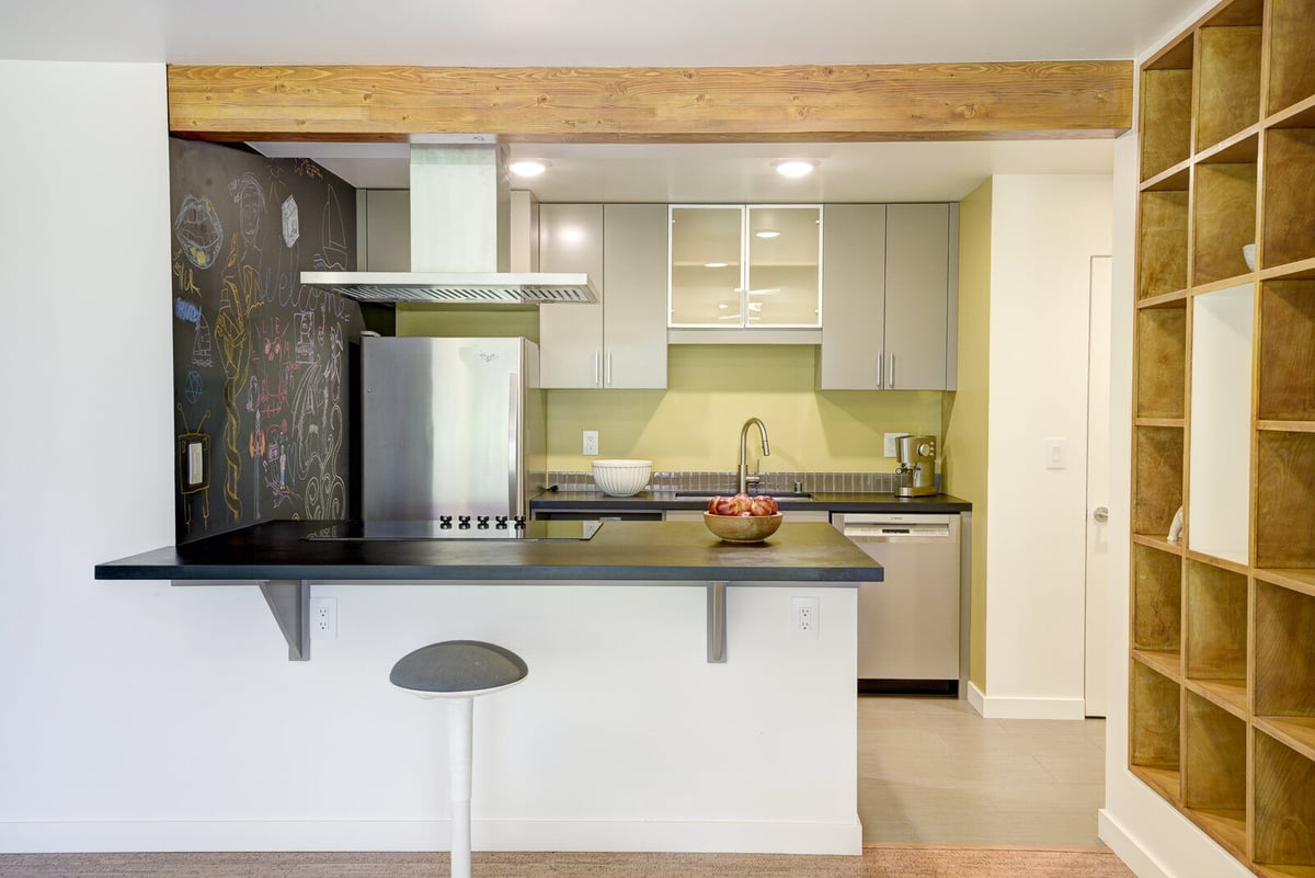 Spacious living area with a garden view in a Seattle basement ADU remodel by CB Construction