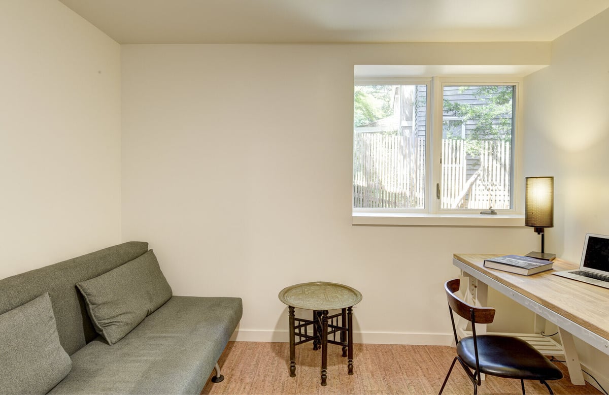 Work desk in a Seattle basement ADU, placed by a window for natural light, designed by CB Construction