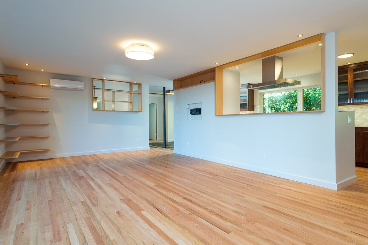 Bright living room with open kitchen view and modern wood cabinets, CB Construction, Seattle