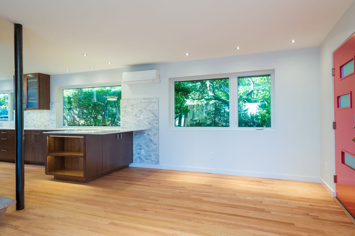 Open-concept kitchen with wood cabinetry and large windows, CB Construction, Seattle