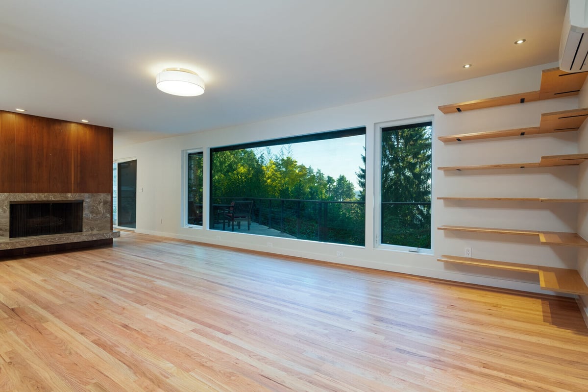 Spacious living room with floor-to-ceiling windows and floating wooden shelves, CB Construction, Seattle