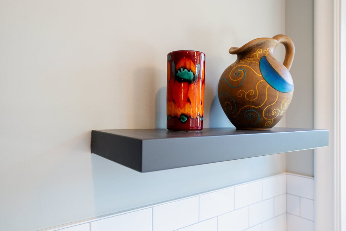 Close-up of colorful vase and pottery on a kitchen shelf in a Seattle home remodeled by CB Construction