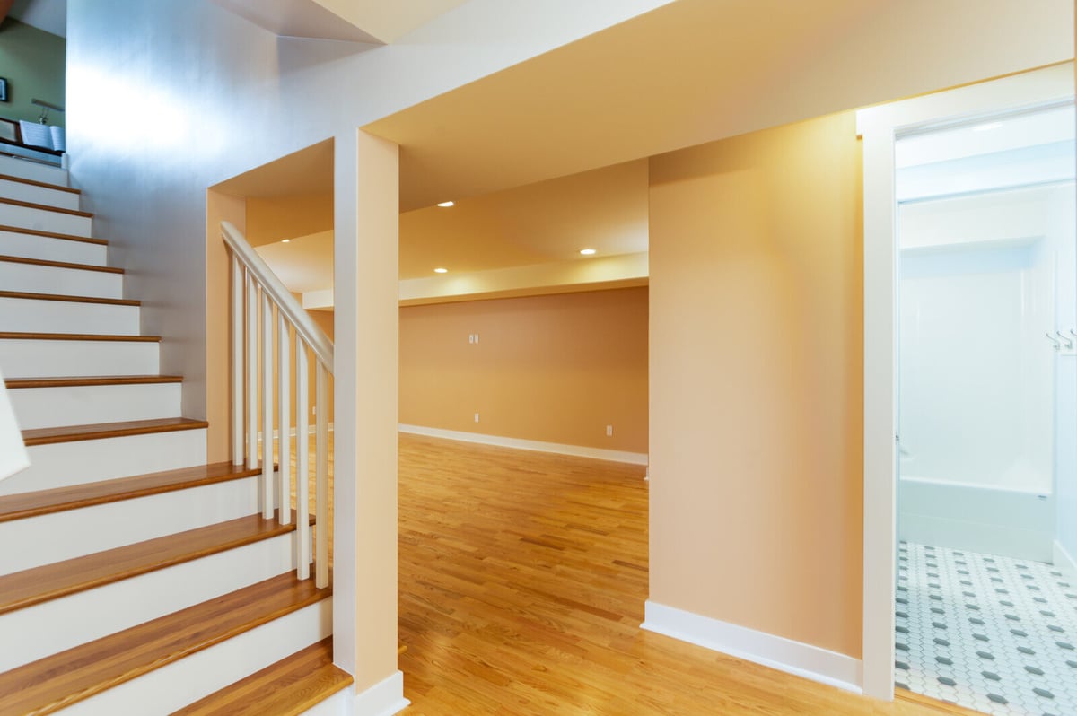 Basement remodel in Seattle featuring light wood floors and recessed lighting, completed by CB Construction