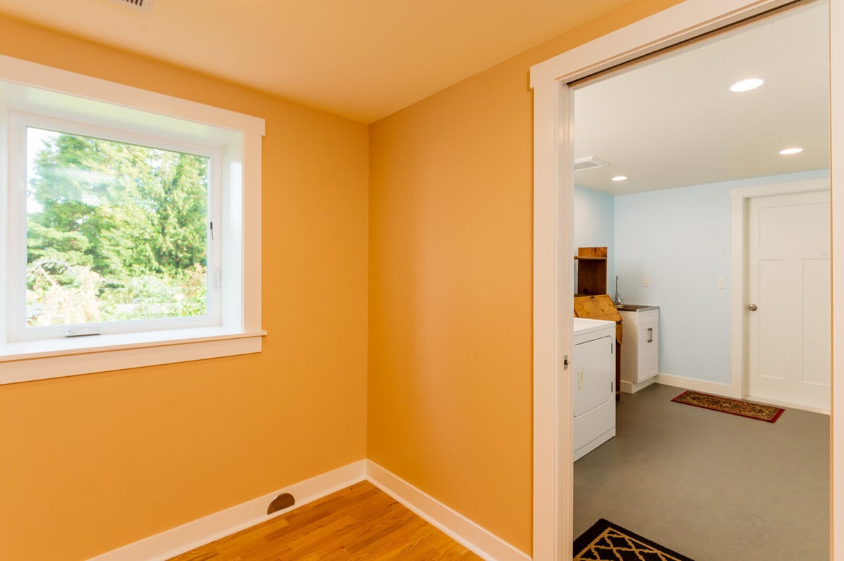 Bright and spacious laundry room in a remodeled Seattle basement with new washer and dryer, by CB Construction