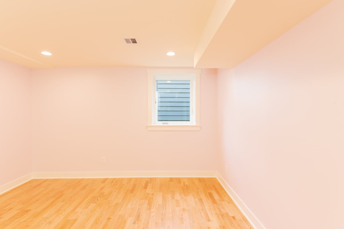 Laundry room in a remodeled Seattle basement with light blue walls and new washer and dryer, by CB Construction