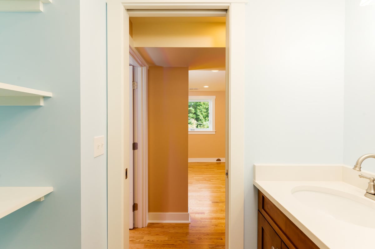 Light blue bathroom in a remodeled Seattle basement featuring modern fixtures, by CB Construction