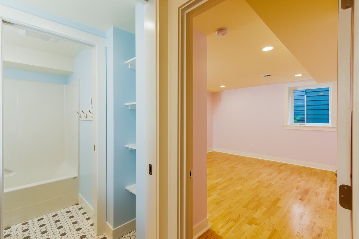 Newly remodeled Seattle basement bathroom with hexagon tile flooring and light blue walls, by CB Construction