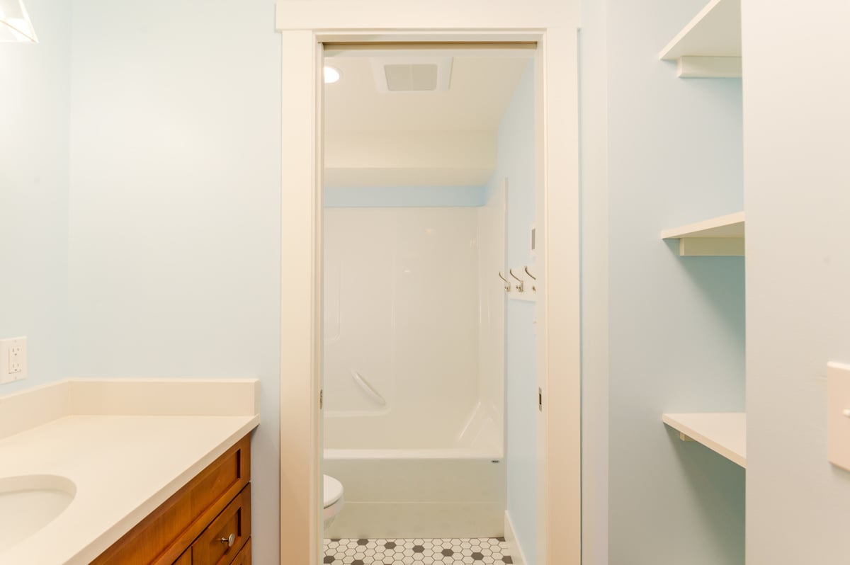 Shower area in a remodeled basement bathroom with modern fixtures in Seattle, by CB Construction