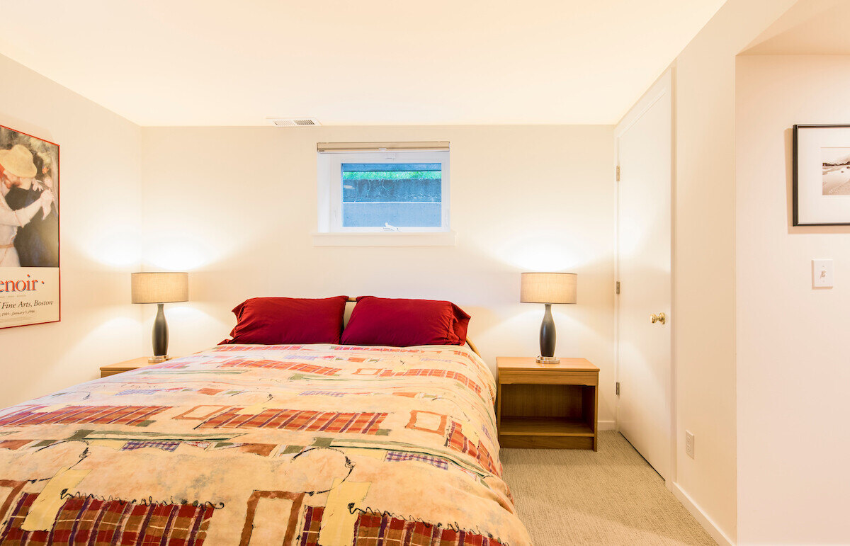 Basement Airbnb bedroom remodel by CB Construction in Seattle with a cozy atmosphere and wall art