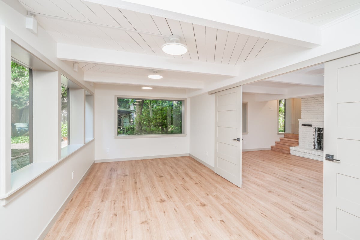Bright living space in a Seattle basement ADU with large windows, remodeled by CB Construction