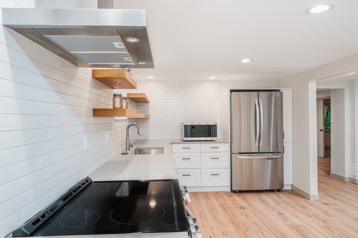 Close-up of a renovated ADU kitchen with stainless steel appliances in Seattle, done by CB Construction