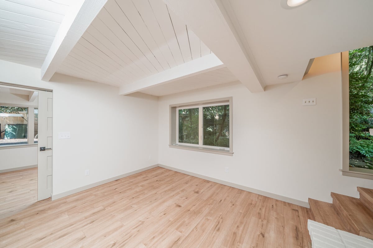 Close-up of a white brick fireplace in a remodeled Seattle basement ADU by CB Construction