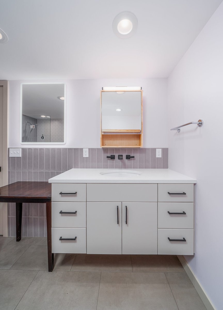 Contemporary bathroom vanity with mirrored cabinet in a Seattle ADU remodel by CB Construction