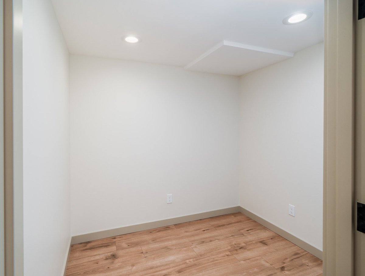 Cozy room in a remodeled Seattle basement ADU by CB Construction, featuring natural wood floors