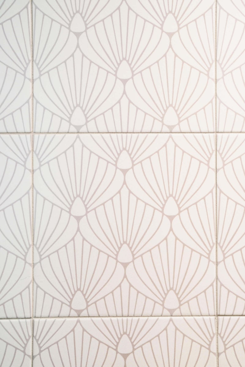 Decorative white tiles with a fan pattern in a Seattle ADU bathroom by CB Construction