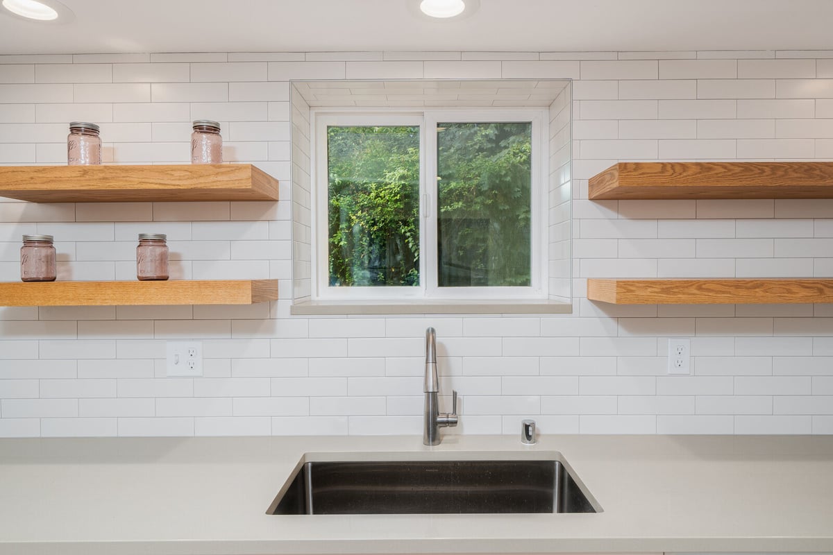 Modern kitchen shelves and sink area in a Seattle ADU, remodeled by CB Construction