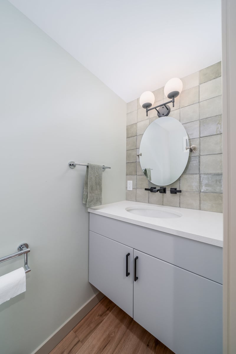 Remodeled bathroom vanity in a Seattle ADU by CB Construction, with modern lighting and tile accents