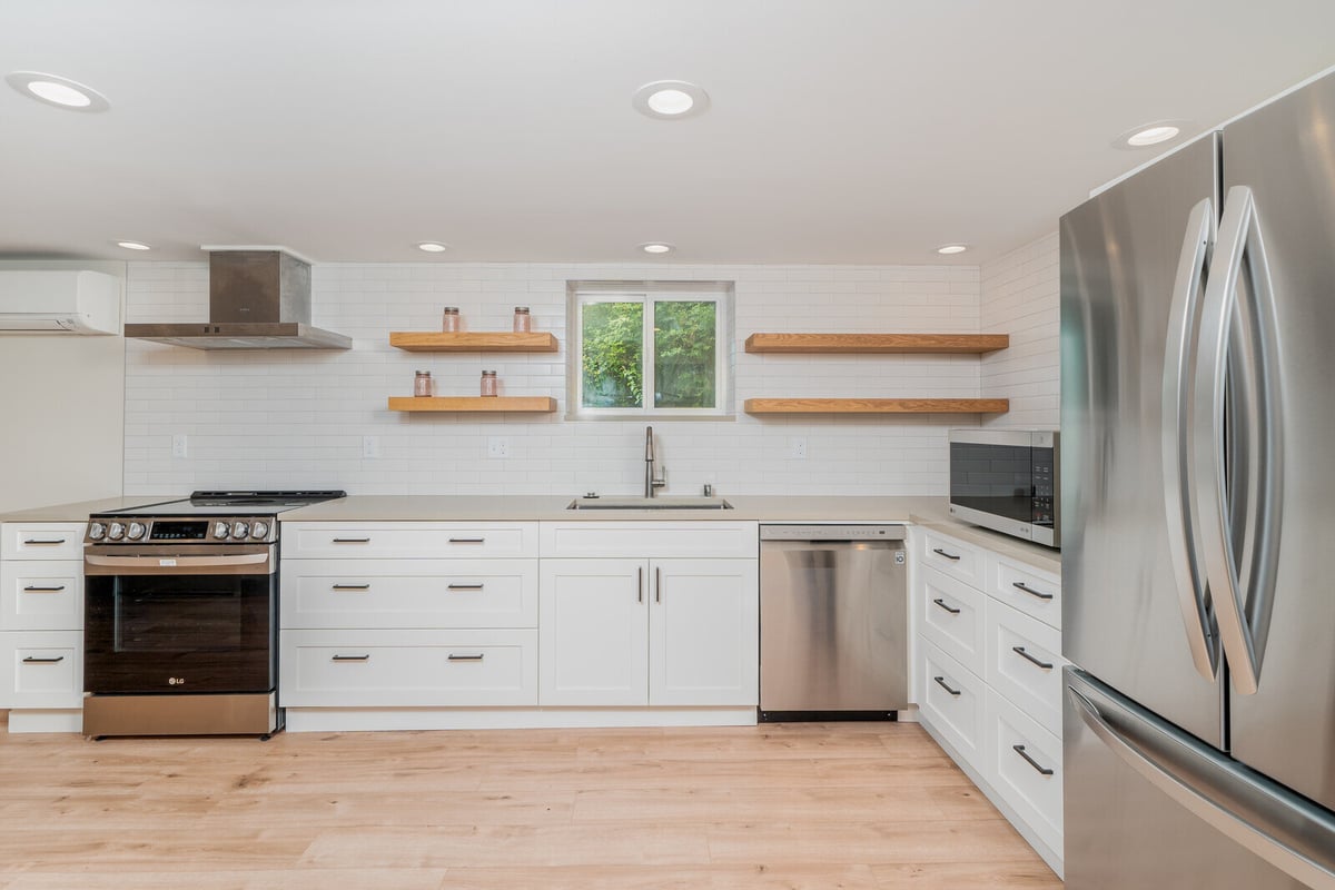 Renovated basement ADU kitchen sink area in Seattle by CB Construction, featuring subway tile backsplash