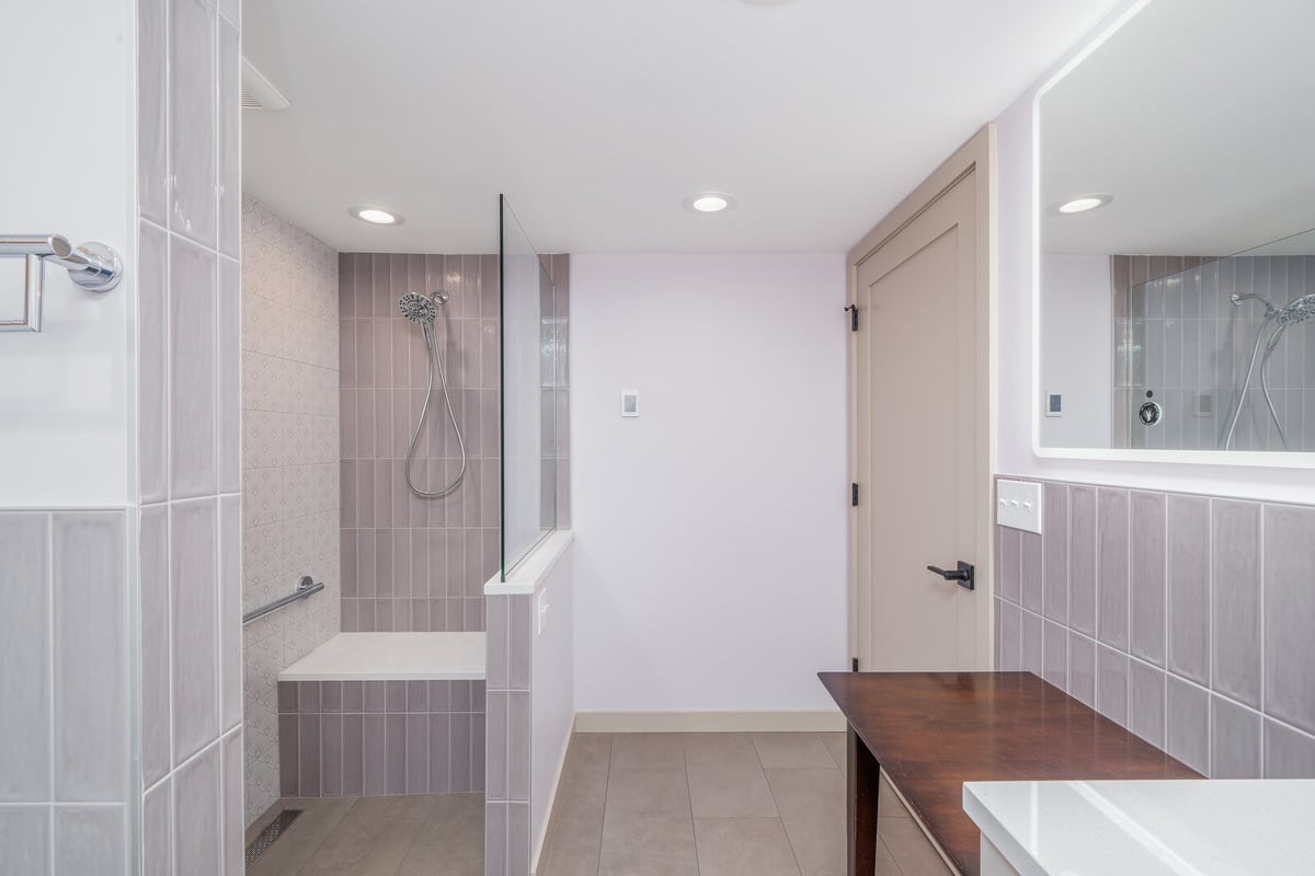 Spacious shower area with glass partition and modern tiles, part of a Seattle basement ADU remodel by CB Construction