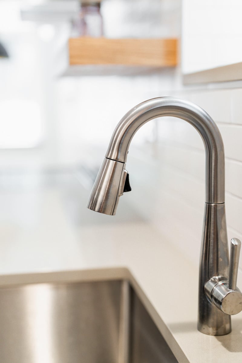Stainless steel kitchen faucet and sink in a remodeled Seattle ADU by CB Construction