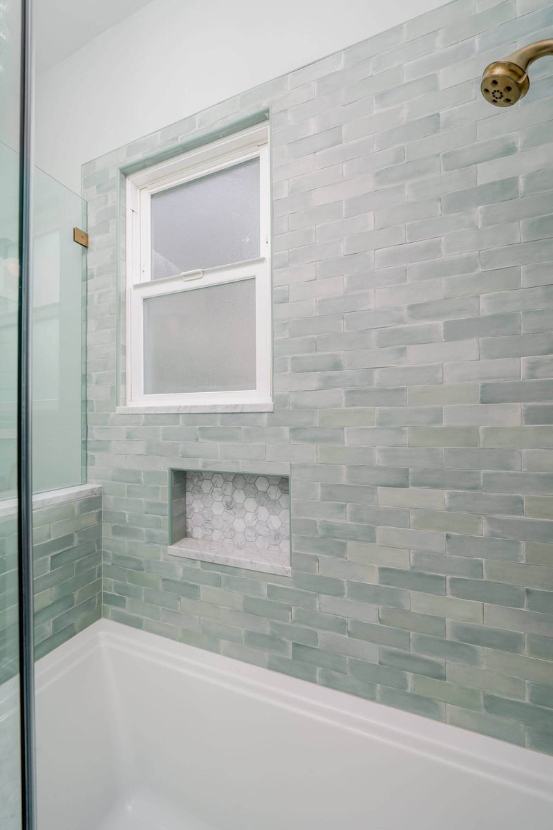 Bathroom window with green tile surround and built-in shelf, remodeled by CB Construction in Seattle