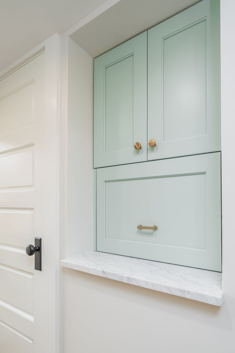 Bright Seattle kitchen remodel with a custom refrigerator and brass hardware by CB Construction