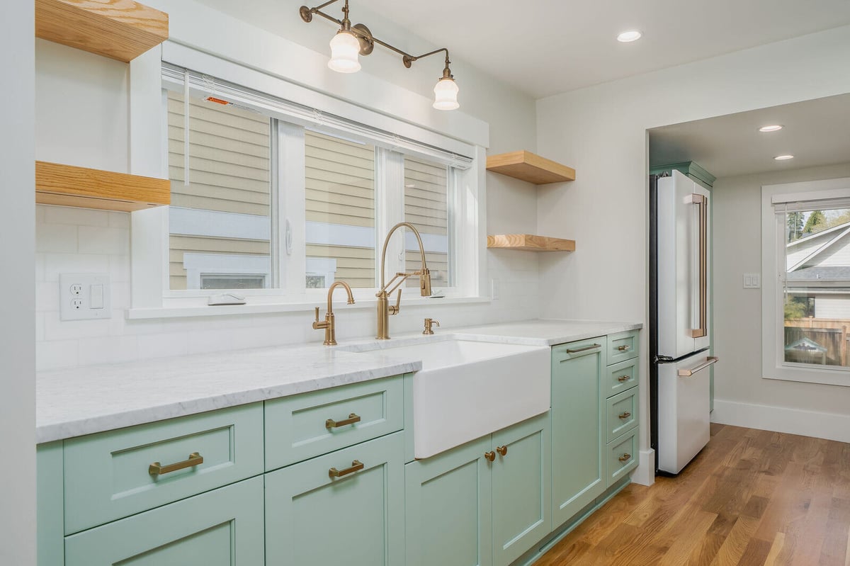 Bright Seattle kitchen with large windows and a deep farmhouse sink, remodeled by CB Construction