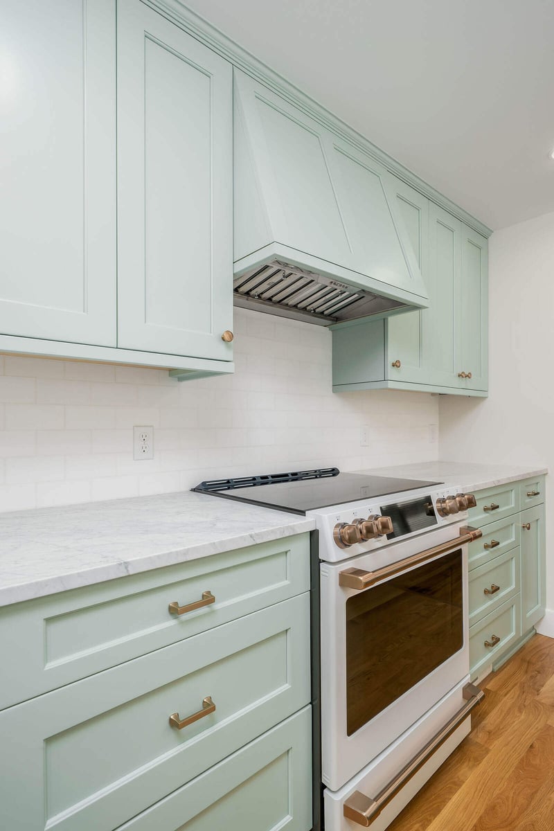 Built-in mint green cabinets with marble shelf in a Seattle kitchen remodel by CB Construction