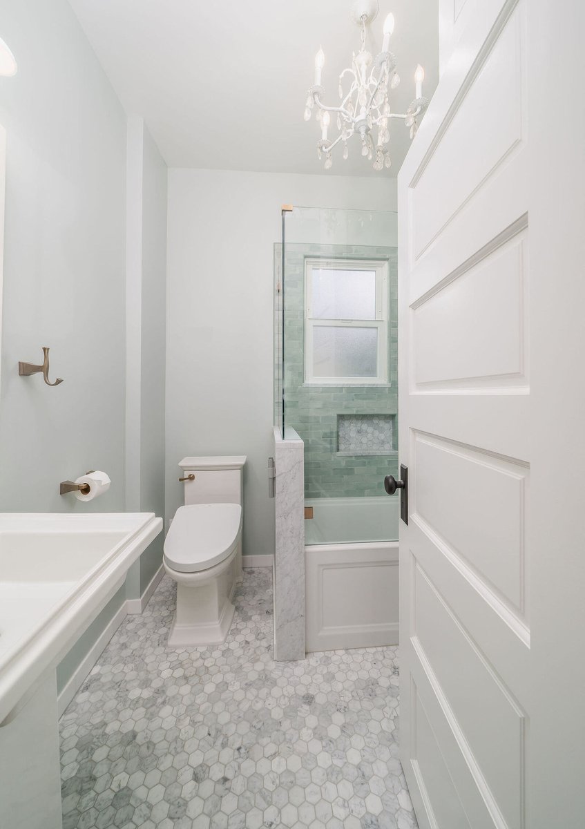 Custom bathroom with pedestal sink and white walls, remodeled by CB Construction in Seattle