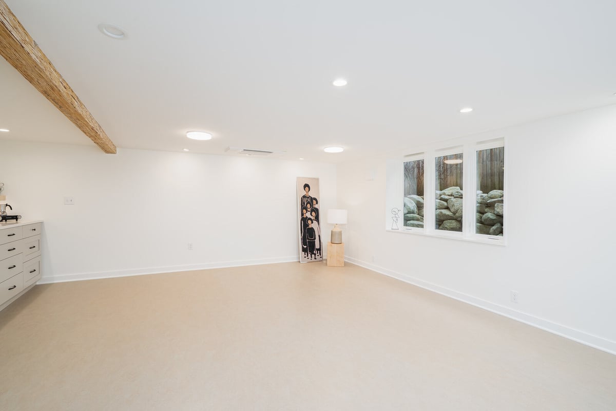 Basement space with bright windows and modern decor in a Seattle renovation by CB Construction