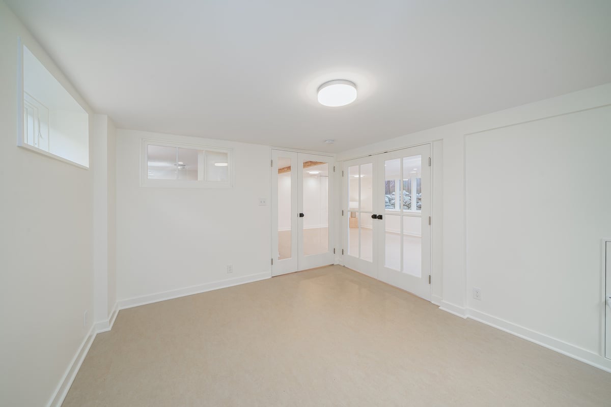Bright, newly renovated basement space with French doors by CB Construction in Seattle