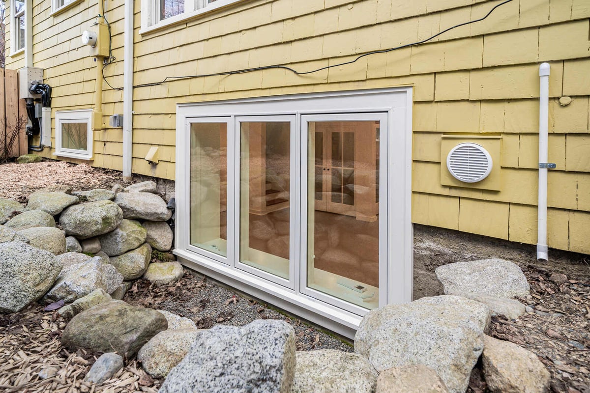 Wide view of basement windows with stone accents in a Seattle renovation by CB Construction